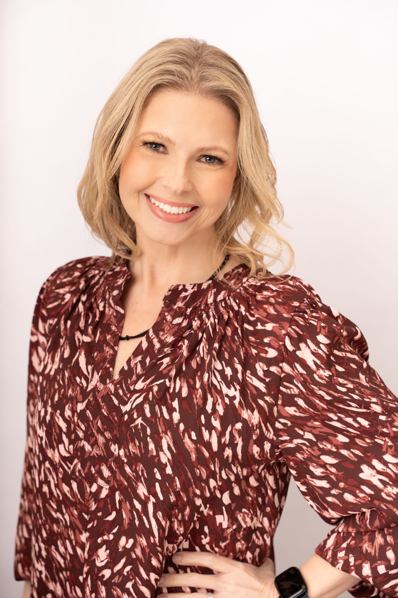 Crystal Rowell smiling in a polished professional portrait